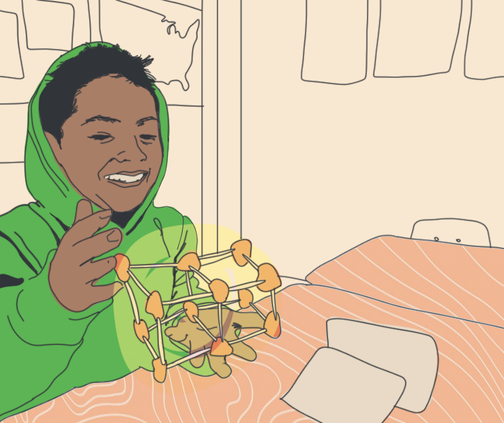 Student in green hoodie playing cube
